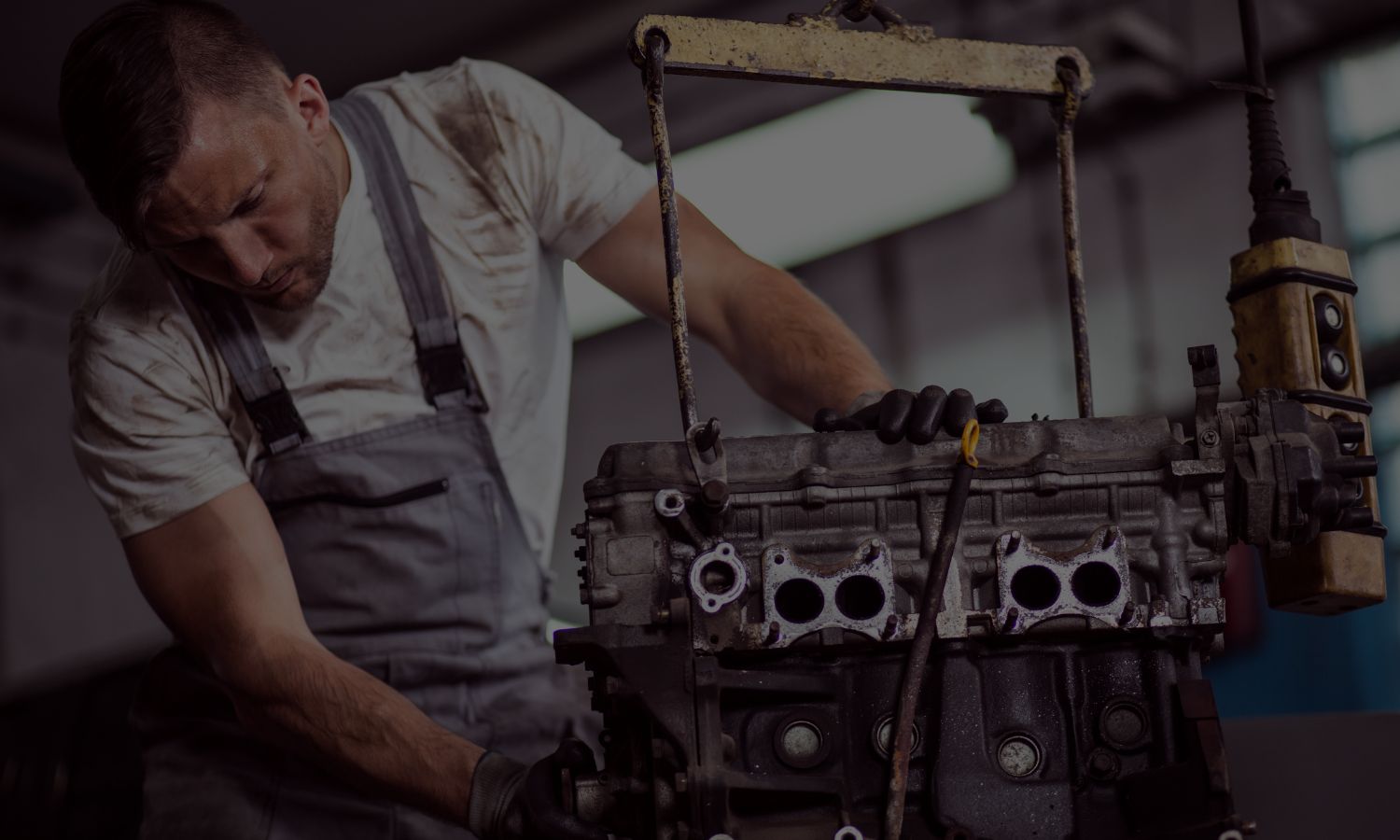 Mechanic holding engine